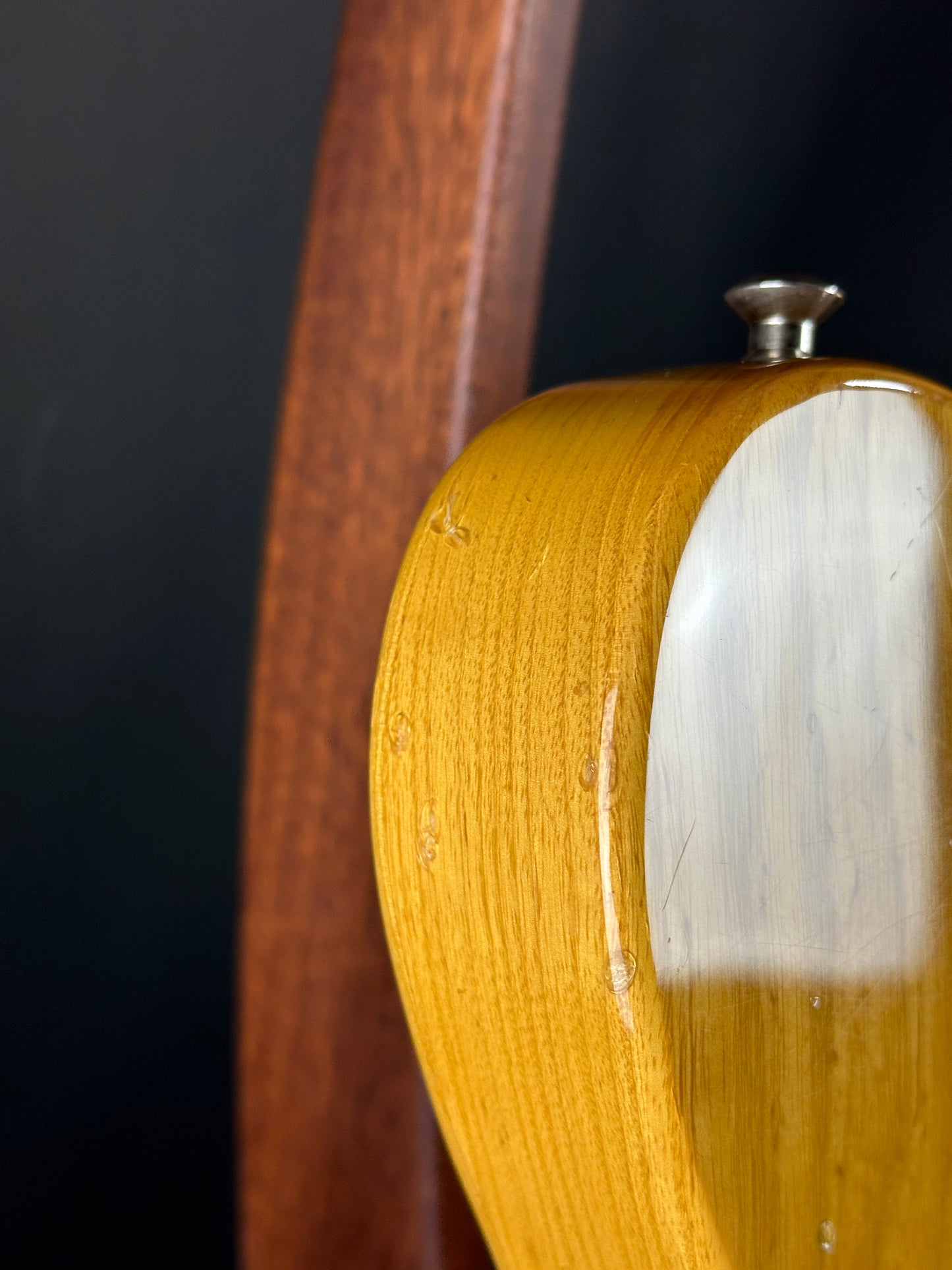 Close-up of a wooden object with a metallic component on a dark background