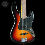 A classic four-string bass guitar with a sunburst finish, featuring a black pickguard, chrome hardware, and a maple neck, shown against a solid black background with a Tone Shop logo in the top left corner.