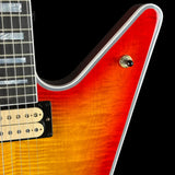 Close-up of a red electric guitar with a black pickguard on a black background