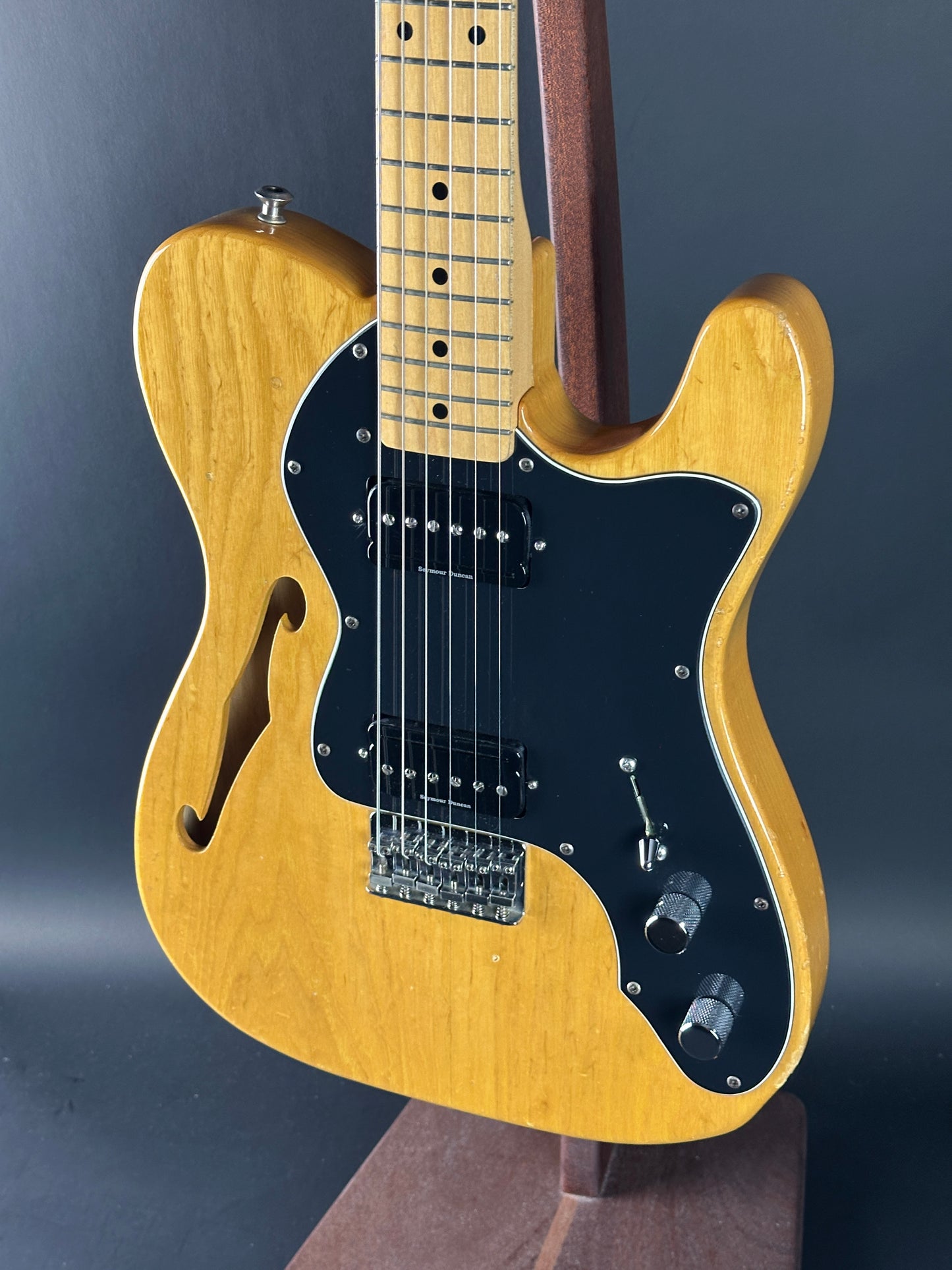 Yellow electric guitar on a dark background