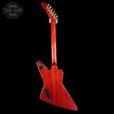Red electric guitar on a black background with 'Tone Shop' logo.