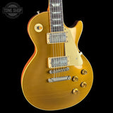 Gold electric guitar on a black background with 'Tone Shop' logo.