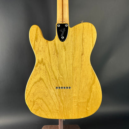 Yellow electric guitar body on a dark gray background