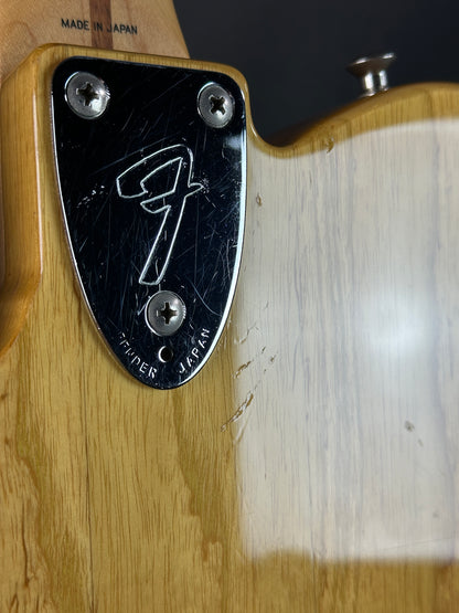 Fender logo on a guitar pickguard with wooden background