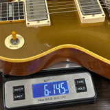 Guitar on a digital scale displaying weight