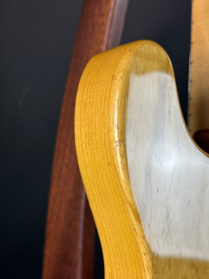 Close-up of a wooden chair armrest on a black background
