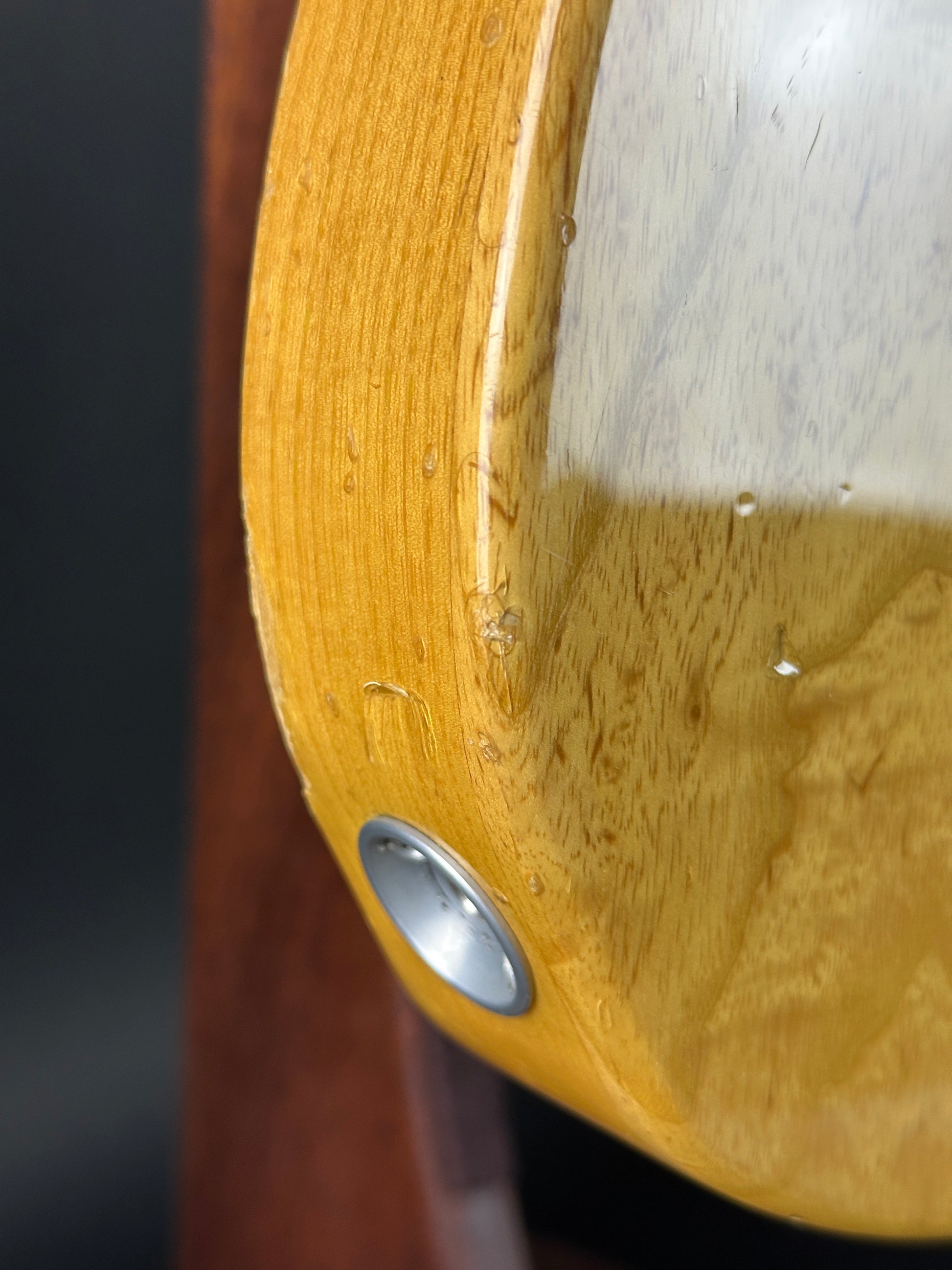 Close-up of a wooden surface with a metal screw