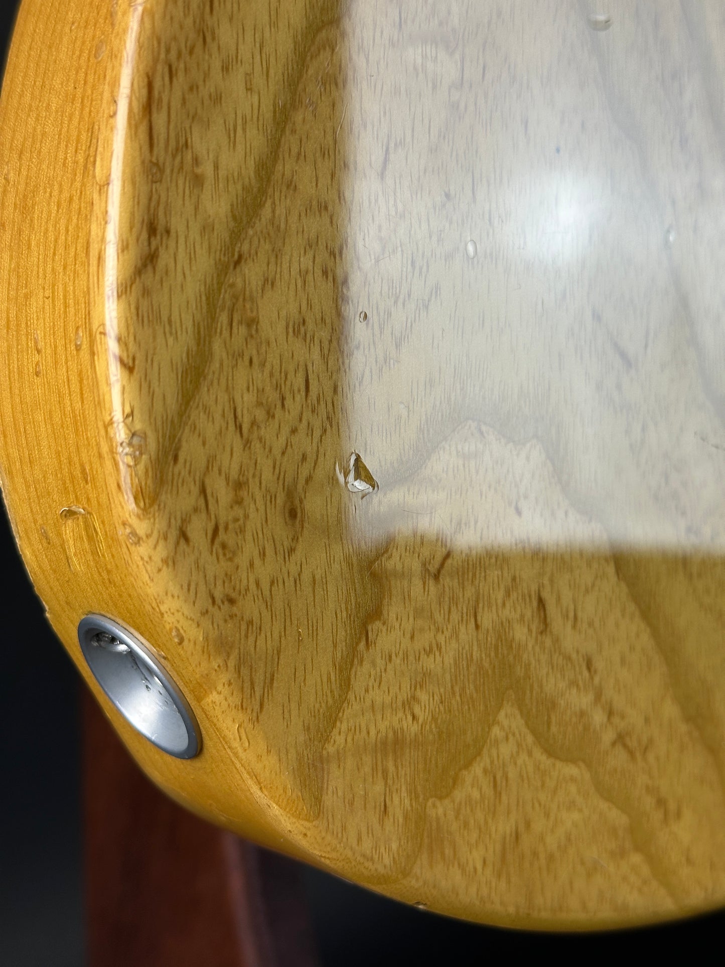 Close-up of a wooden stool with a metal footrest.