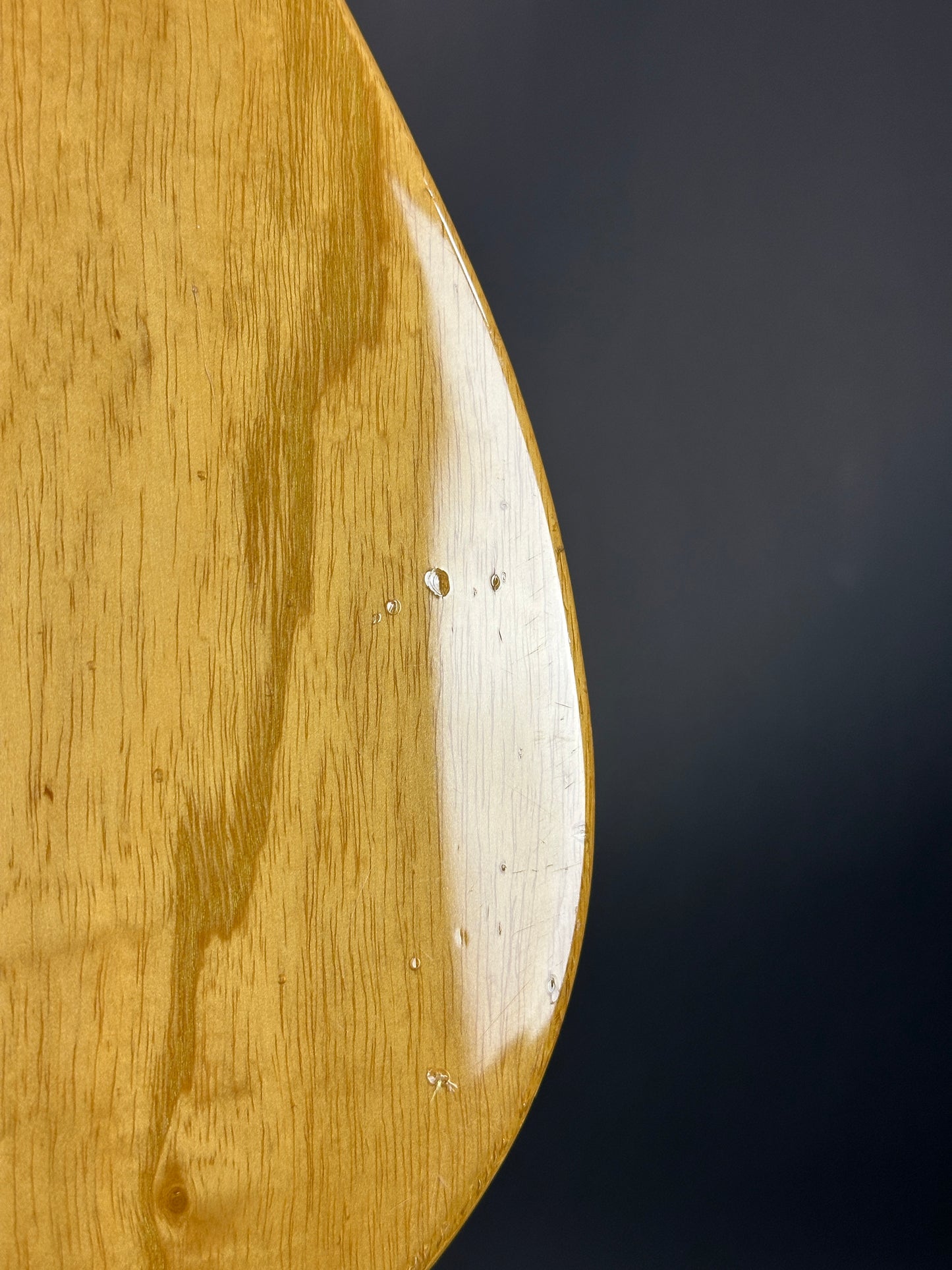 Close-up of a wooden surface with a dark background