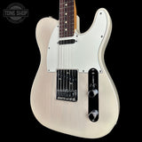 A white electric guitar with a natural wood finish, black hardware, and a white pickguard, shown against a solid black background with a Tone Shop watermark in the top left corner.