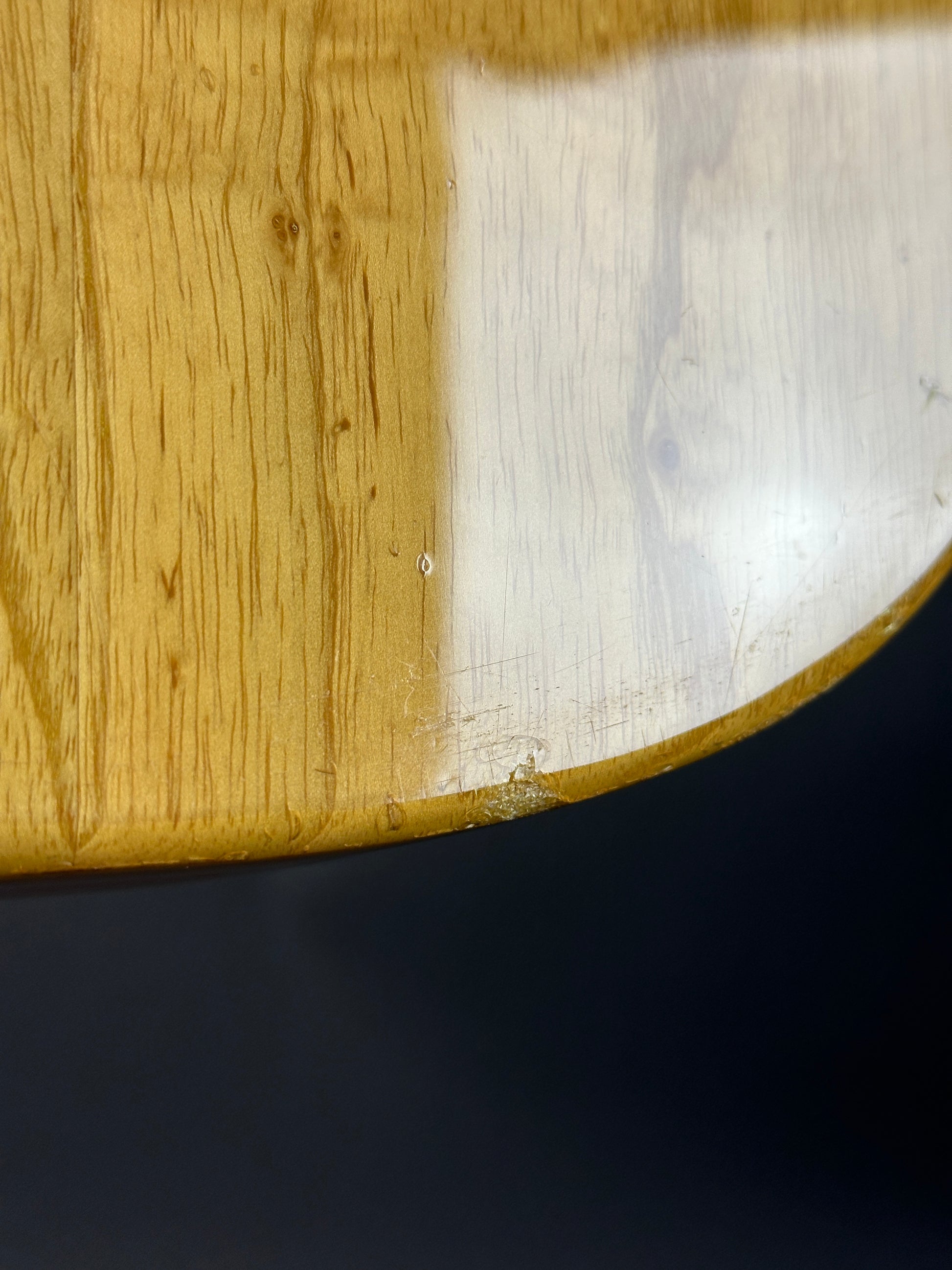 Close-up of a wooden surface with a dark background