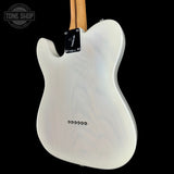 The back of a white electric guitar with a natural wood neck and black hardware, shown against a solid black background with a Tone Shop watermark in the top left corner.