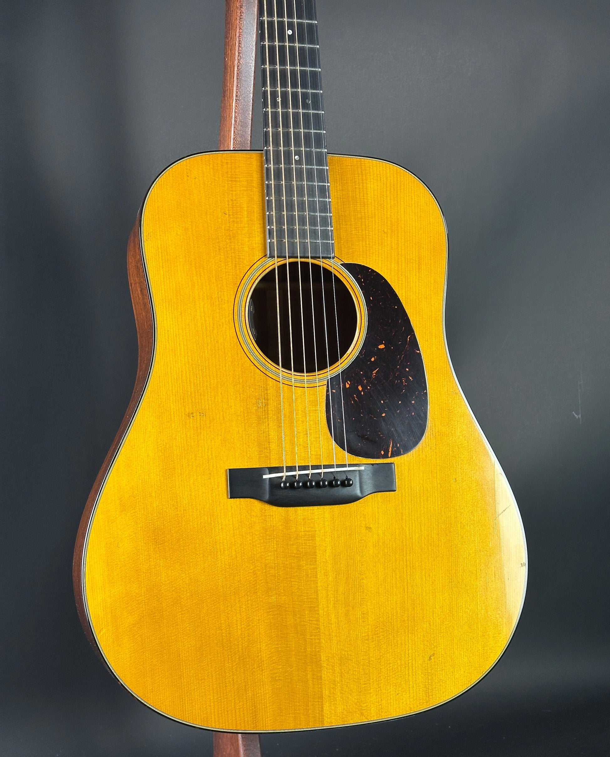 Acoustic guitar with a yellow finish on a dark background