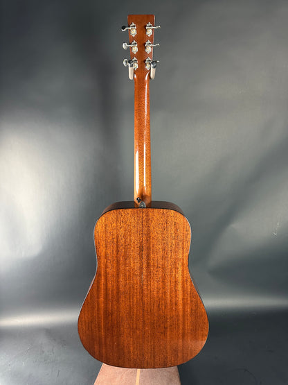 Wooden acoustic guitar on a gray background