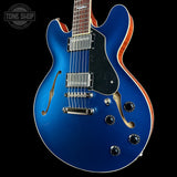Blue electric guitar with a black background