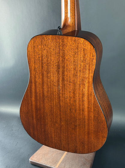 Wooden acoustic guitar on a gray background