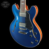 Blue electric guitar with a black background