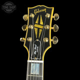 Gibson guitar headstock with brand logo on a black background