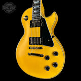 Yellow electric guitar on a black background with 'Tone Shop' logo.