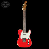 Red electric guitar with a white pickguard on a black background, featuring 'Tone Shop' branding.