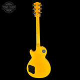 Yellow electric guitar on a black background with 'Tone Shop' logo.