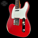 Red electric guitar with white pickguard on a black background, featuring 'Tone Shop' logo.