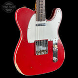 Red electric guitar with a white pickguard on a black background, featuring 'Tone Shop' branding.