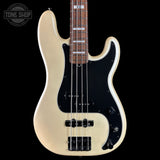 A classic four-string bass guitar with a cream-colored body, a black pickguard, and a dark brown maple fretboard, shown against a solid black background.
