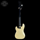 A cream-colored electric guitar shown from the back against a solid black background, with a Tone Shop watermark in the top-left corner.