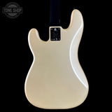 The back of a cream-colored electric guitar body, photographed against a solid black background. A circular Tone Shop watermark is visible in the top-left corner.