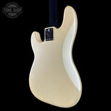The back of a Fender Stratocaster electric guitar in a glossy cream finish, shown against a solid black background with a Tone Shop watermark in the top left corner.