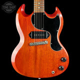 A classic electric guitar with a reddish-orange sunburst finish, black pickguard, and chrome hardware, shown against a solid black background with a Tone Shop watermark in the top-left corner.