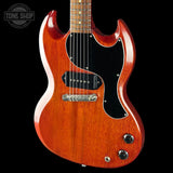 A classic electric guitar with a reddish-orange sunburst finish, black pickguard, and chrome hardware, shown against a solid black background with a Tone Shop watermark in the top left corner.