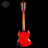 The back view of a classic Gibson SG electric guitar with a glossy red cherry finish, shown against a solid black background with a Tone Shop watermark in the top left corner.