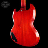 The rear view of a Gibson SG electric guitar with a glossy red cherry finish, shown against a solid black background. A Tone Shop watermark is visible in the top-left corner.