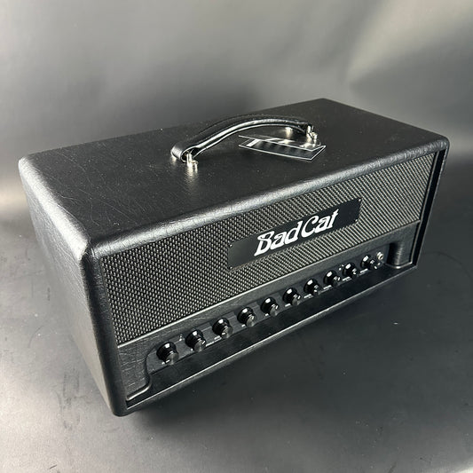 Black guitar amplifier head with 'Bad Cat' branding on a gray background