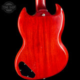 The back of a red electric guitar with a glossy red finish, shown against a solid black background. A Tone Shop watermark is visible in the top left corner.