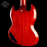 The rear view of a Gibson SG electric guitar with a glossy red cherry finish, shown against a solid black background. A Tone Shop watermark is visible in the top-left corner.