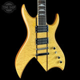 A double-cutaway electric guitar with a natural flamed maple top and black hardware, shown against a solid black background with a Tone Shop watermark in the upper left corner.