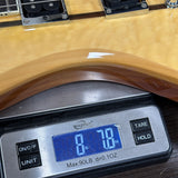 A close-up of a guitar body resting on a digital scale, showing the scale reading 8.70 lbs.