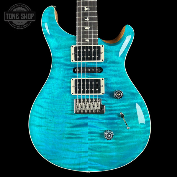 Turquoise electric guitar on a black background with 'Tone Shop' logo.