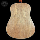 Close-up of a wooden acoustic guitar back with 'Tone Shop' logo.