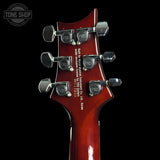 Guitar headstock with PRS tuning pegs on a black background, featuring the Tone Shop logo.