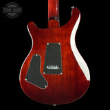 Back view of a red electric guitar with a visible brand logo in the corner.
