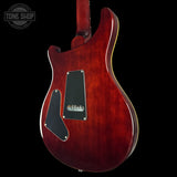 Red electric guitar on a black background with 'Tone Shop' logo.