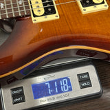 Guitar on a digital scale displaying weight