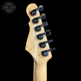 Guitar headstock with tuning pegs on a black background, featuring the Tone Shop logo.