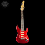Red electric guitar with a black background