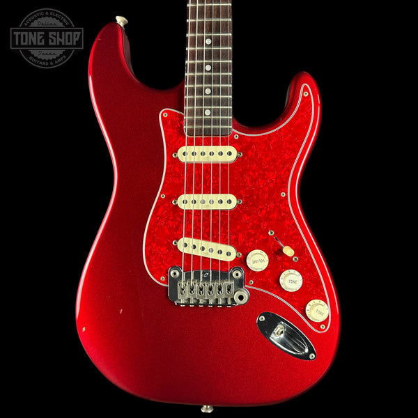 Red electric guitar with a black background