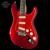 Red electric guitar on a black background with 'Tone Shop' logo.
